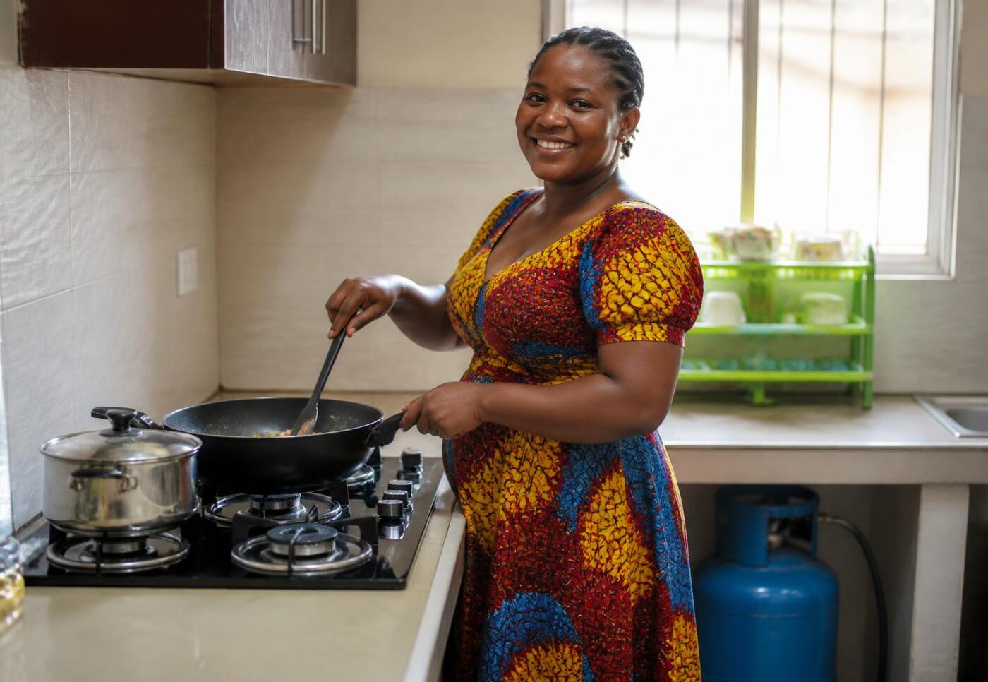 Customer cooking with LPG cooking gas supplied by FAMGAS in Iseyin, Oyo State